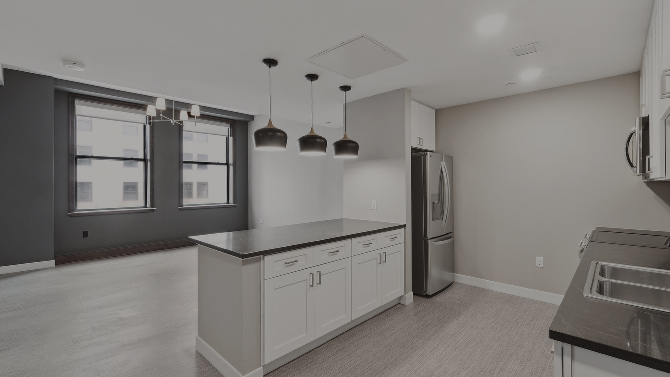 Bright, modern kitchen featuring sleek cabinetry, stainless steel appliances, and elegant pendant lighting, perfect for culinary enthusiasts.