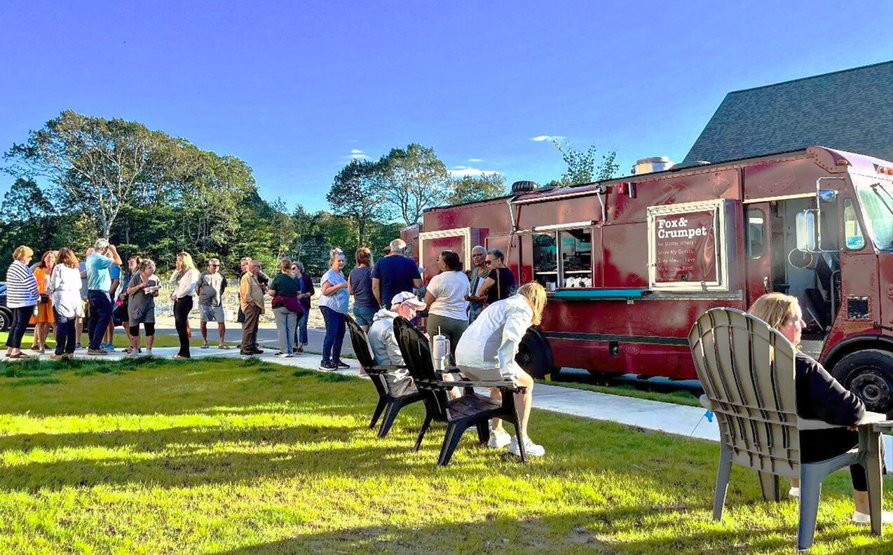 Residents lined up at a food truck during an outdoor event at The Arbella at Bramble Hill