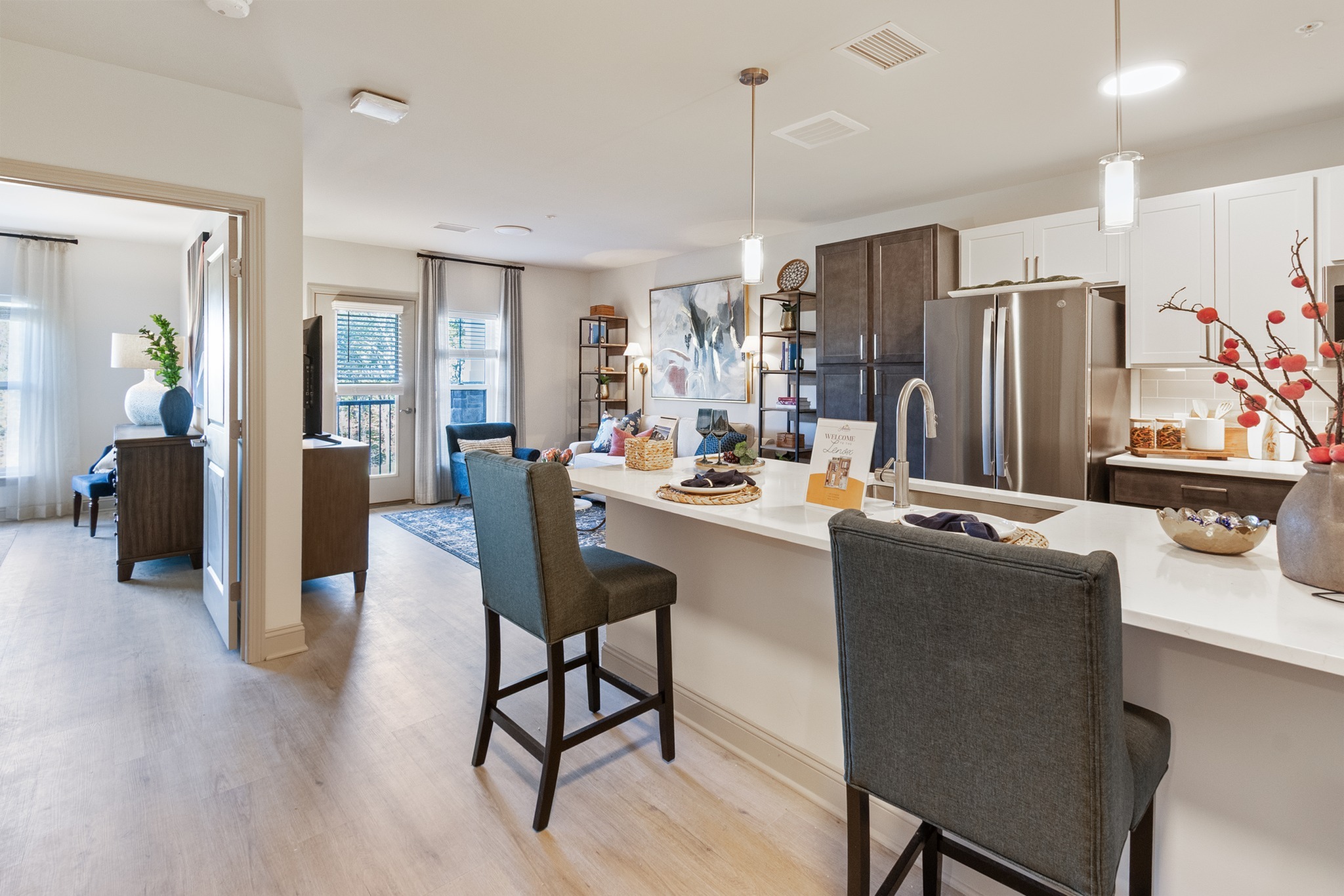 Bright, open-concept apartment kitchen and living room at The Arbella at Bramble Hill