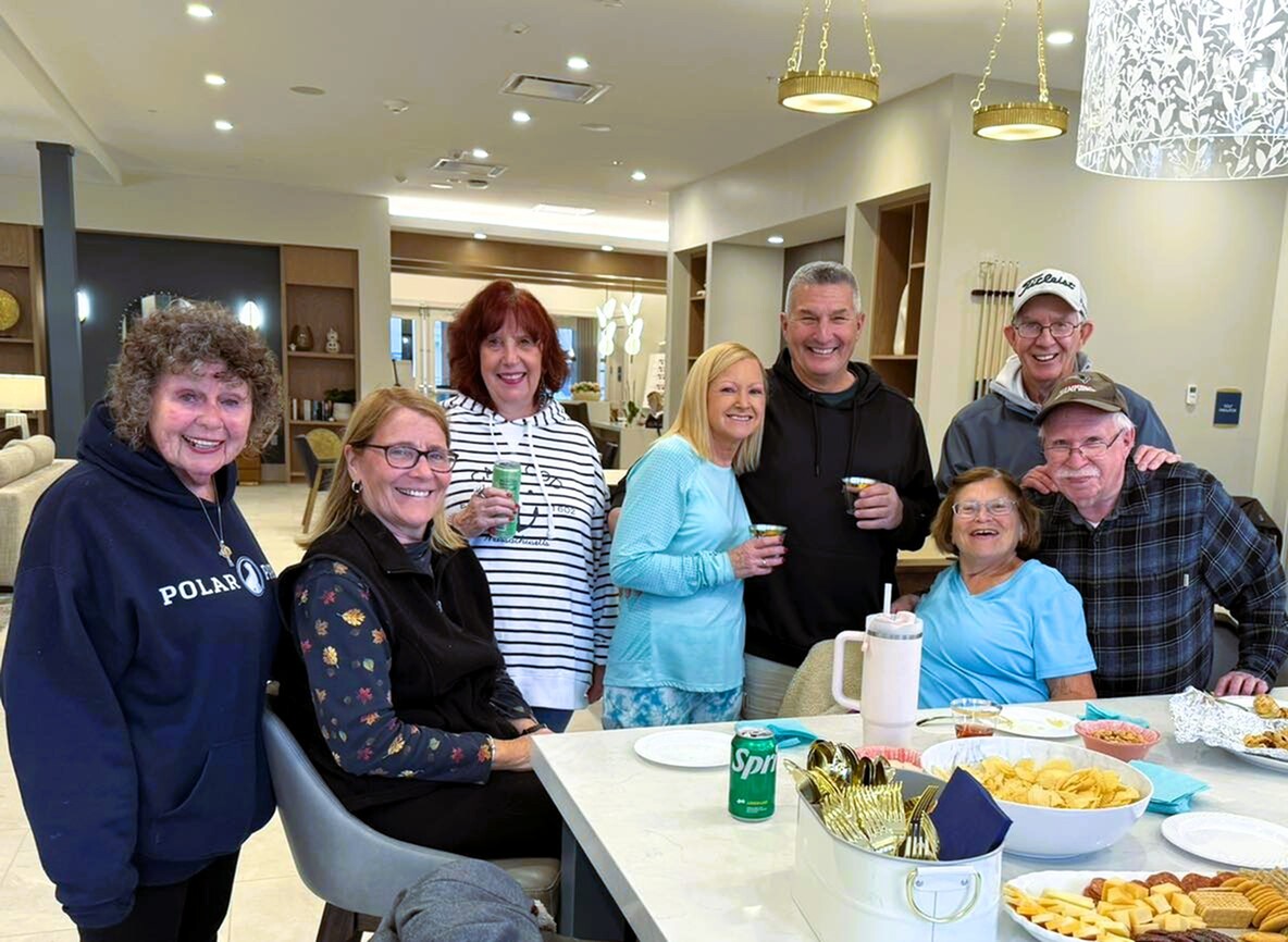 Group of Arbella residents smiling together during a social gathering