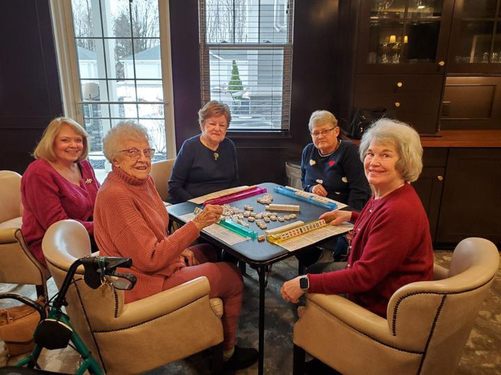 A group of residents sitting together playing a board game