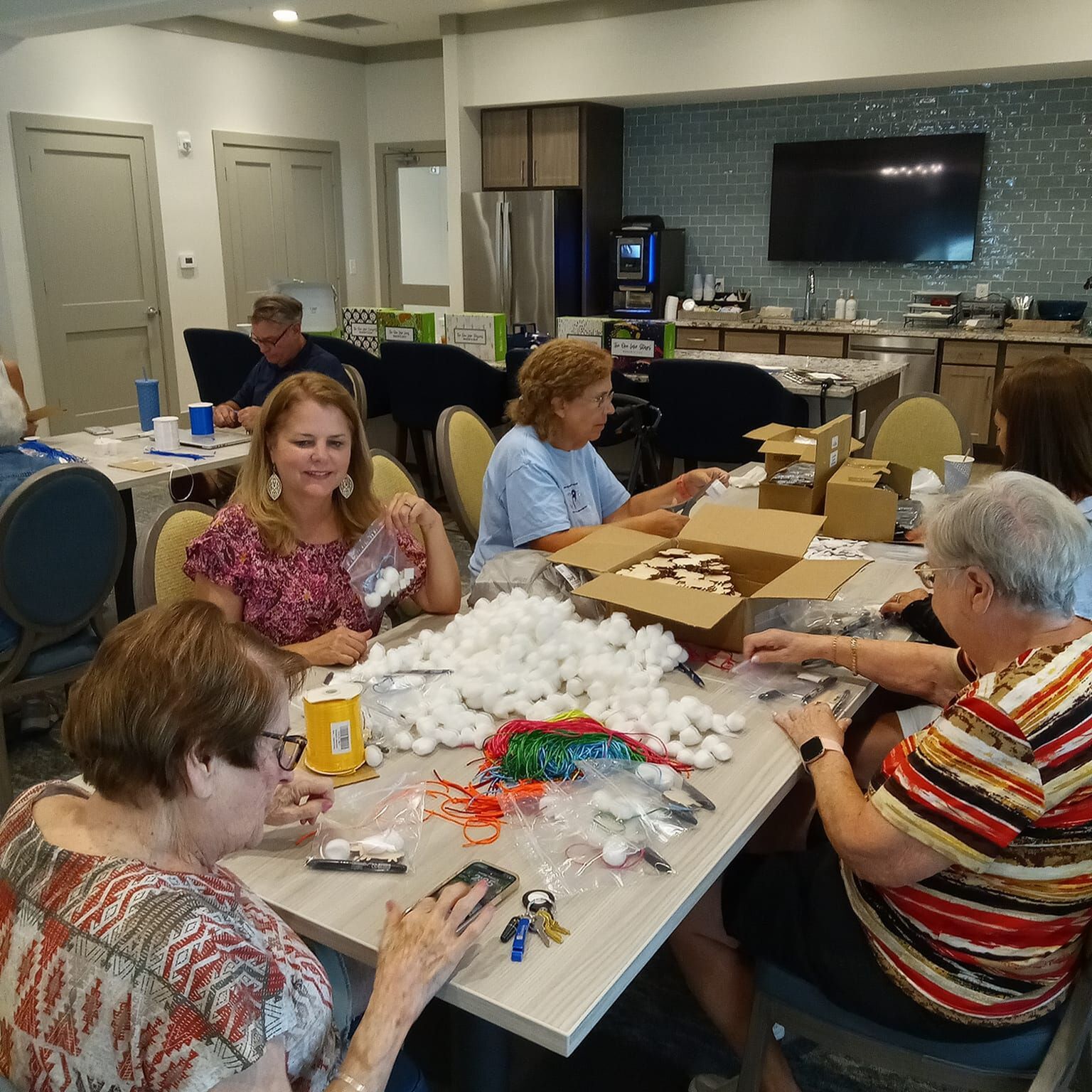 A group of residents sitting together making crafts