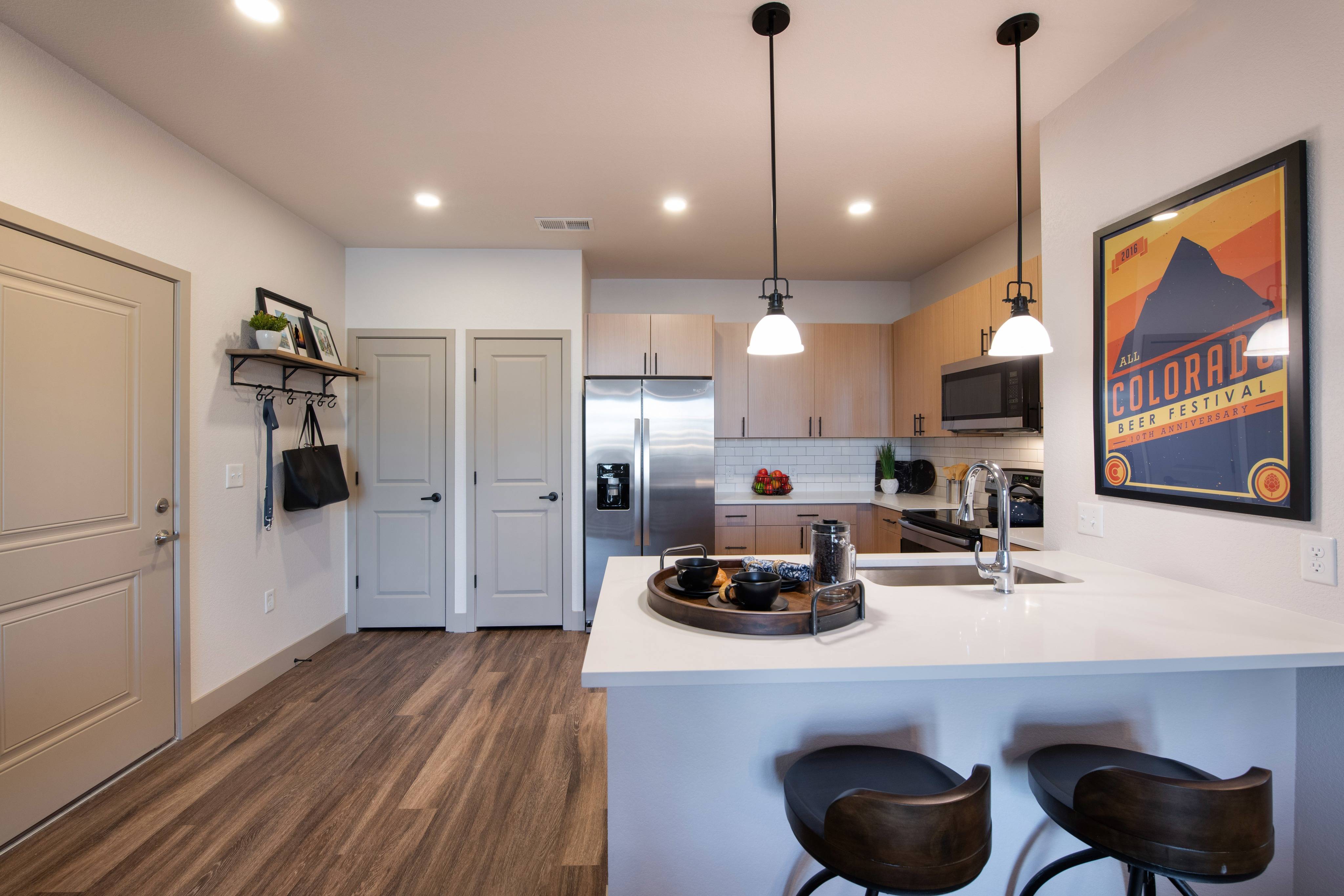 Kitchen faucets with pull-down sprayers