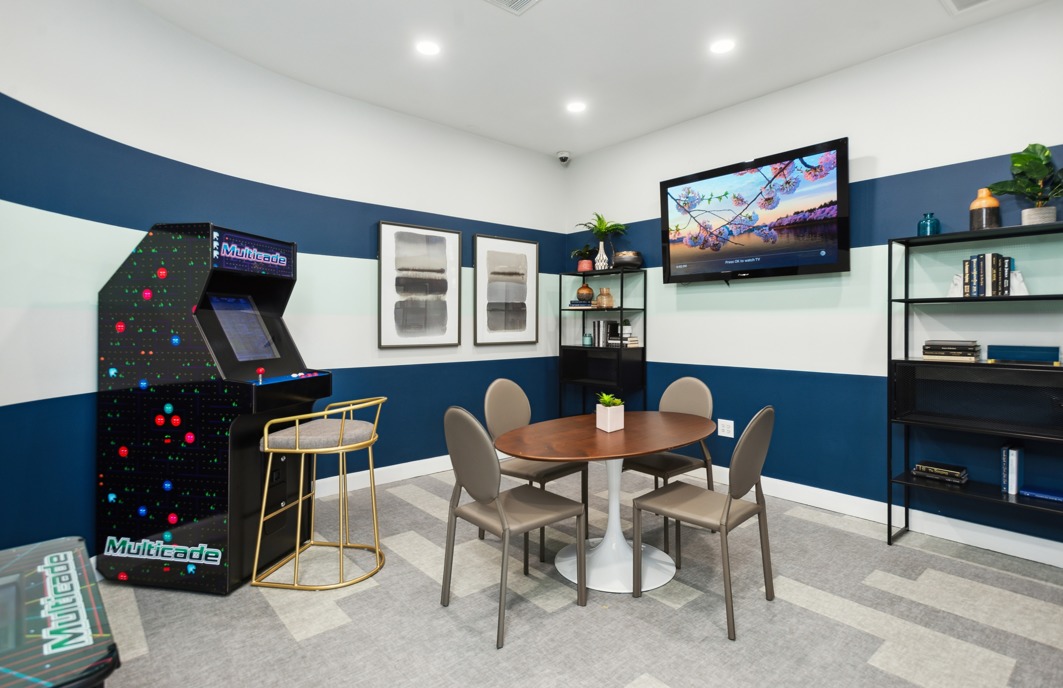 club house arcade game, seating, & big screen San Cierra | Houston, TX Apartments