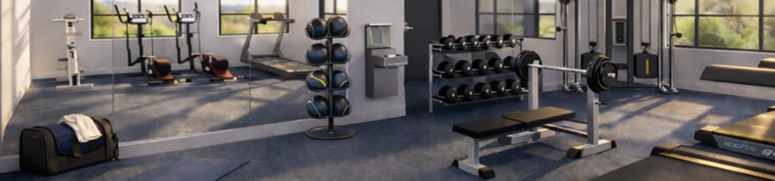 Modern fitness center with state-of-the-art equipment, including treadmills, weight machines, and free weights under stylish ceiling fans.