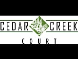 Distinctive logo of Cedar Creek Court featuring elegant green and white design elements.