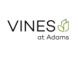 Vibrant 'Vines at Adams' logo featuring modern typography and a subtle leaf design.