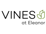 Logo for Vines at Eleanor featuring modern typography with a green leaf design.