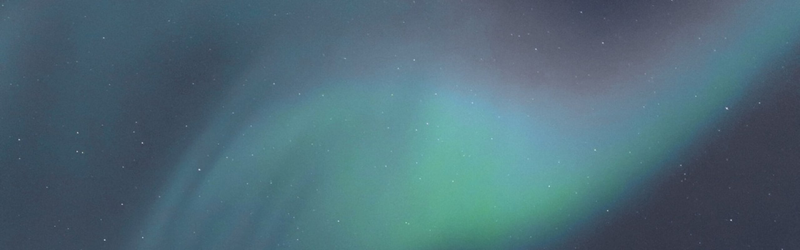 Mesmerizing display of the Northern Lights with vibrant green and blue hues against a starry night sky.