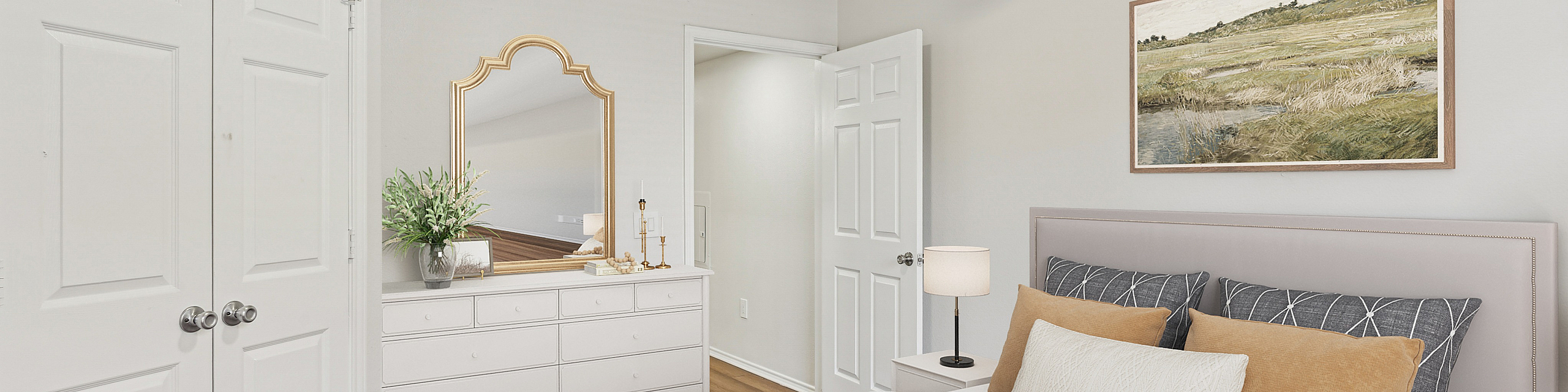 Bright and inviting bedroom featuring a comfortable bed with stylish pillows, elegant dresser with mirror, modern ceiling fan, and tasteful decor for a serene atmosphere.