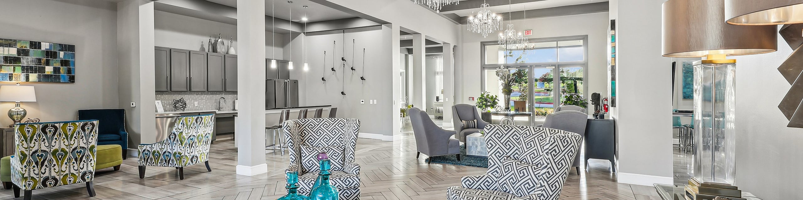 Elegant open-concept living area with stylish chairs, chic chandeliers, and a luxurious modern design.