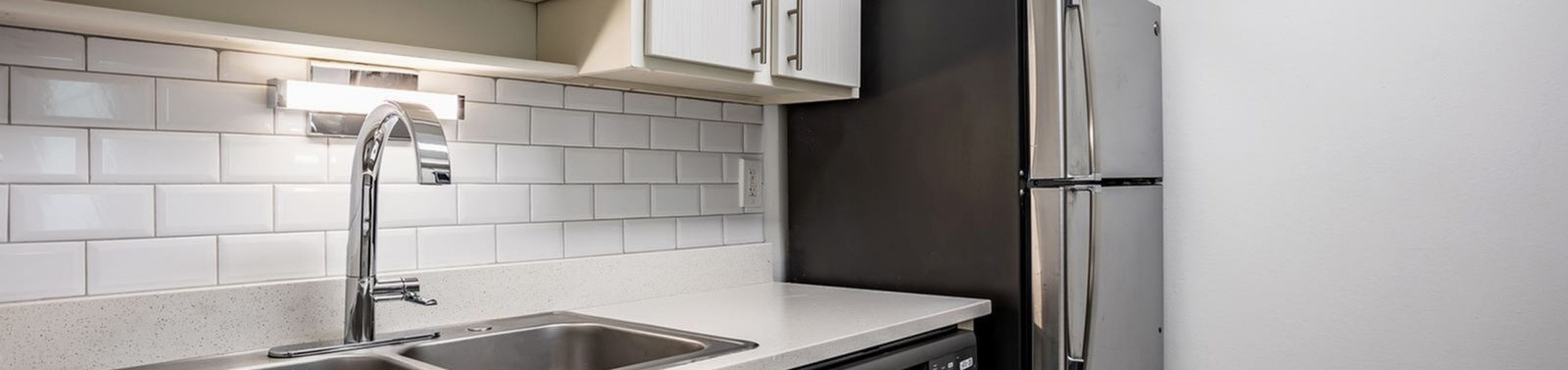 Renovated kitchen with stainless sink at Nordica Bay