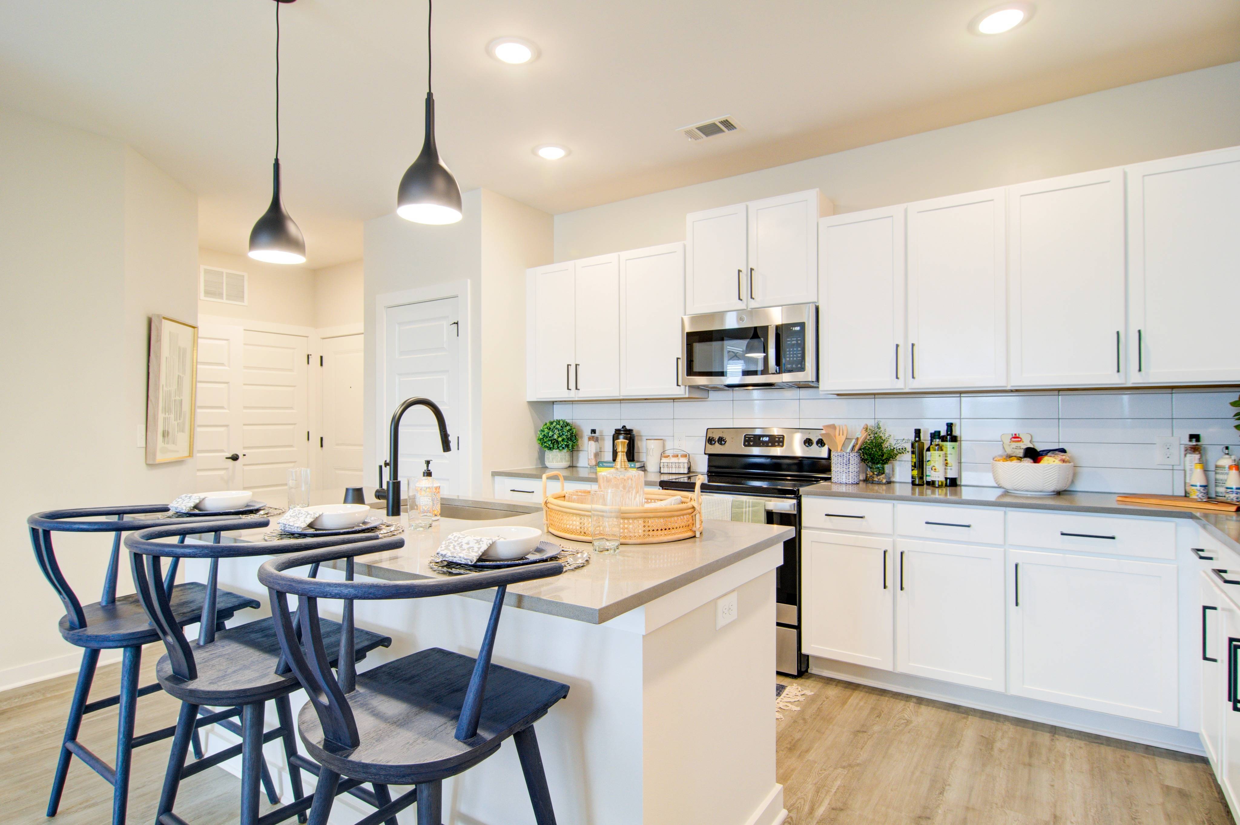Designer grey or white shaker-style cabinetry with high-end tile backsplash