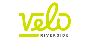 Vibrant and modern Velo Riverside logo, featuring sleek typography in bold lime green and clean design aesthetic.