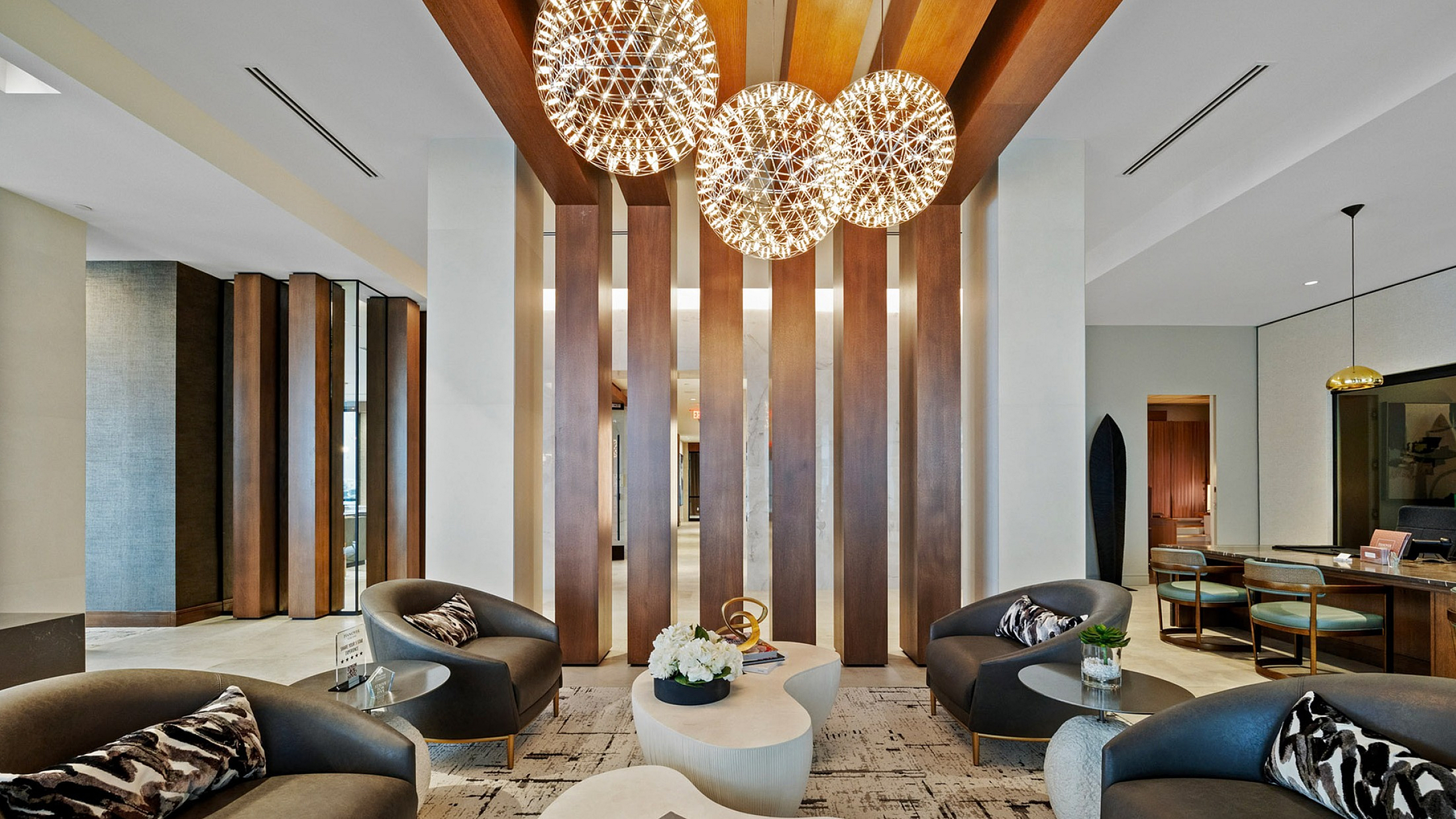 Luxurious lobby area with stylish seating, artistic ceiling lights, and contemporary decor, perfect for relaxation.
