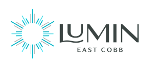 Modern and elegant logo for Lumin East Cobb, featuring a radiant sunburst design with a sleek and stylish typeface.