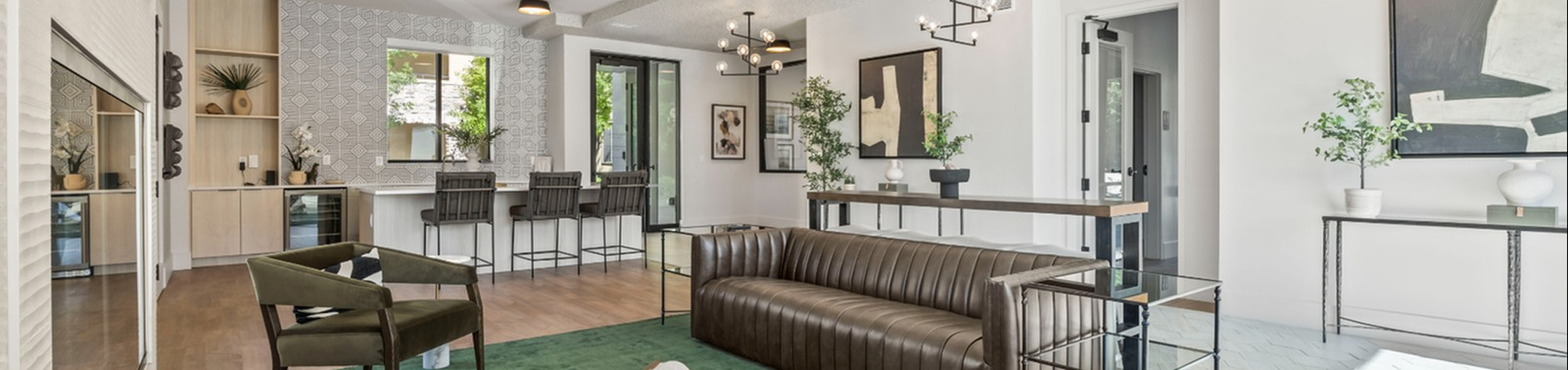 Modern living room with sleek furnishings, an elegant bar area, and contemporary lighting accents, perfect for entertaining.