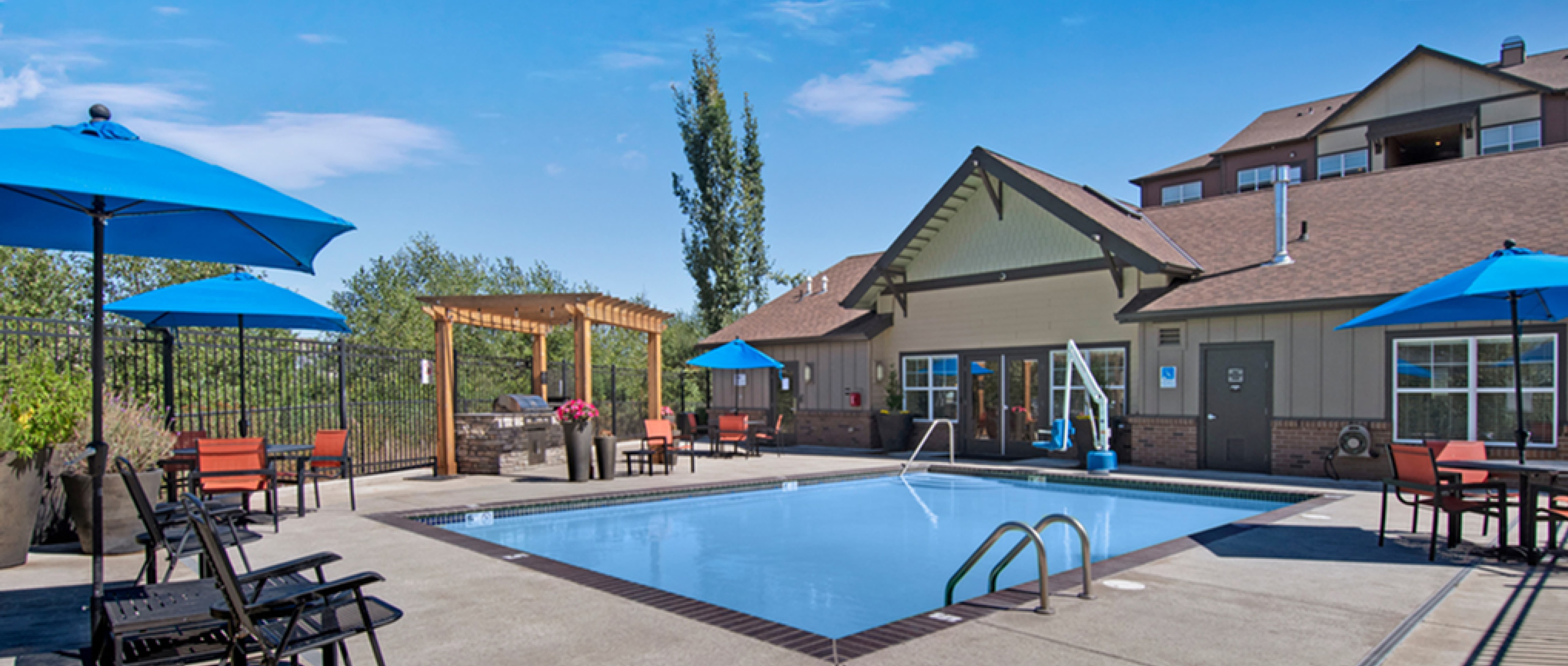 Element 170 pool area and club house with chairs around the pool