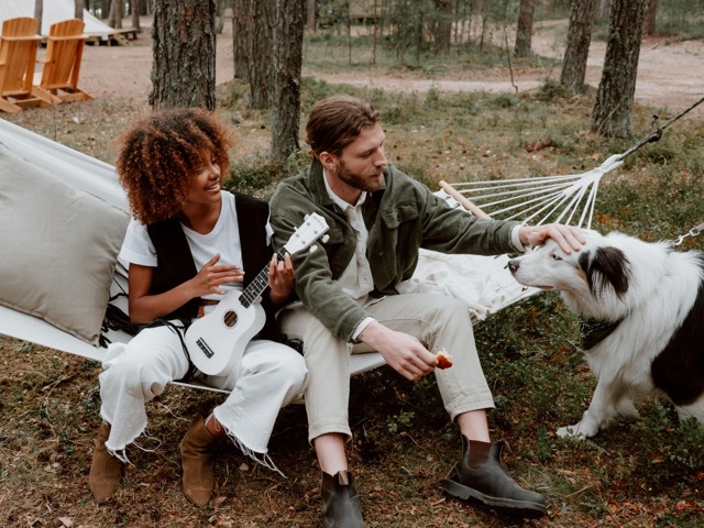 Friends hanging on a hammock with dog