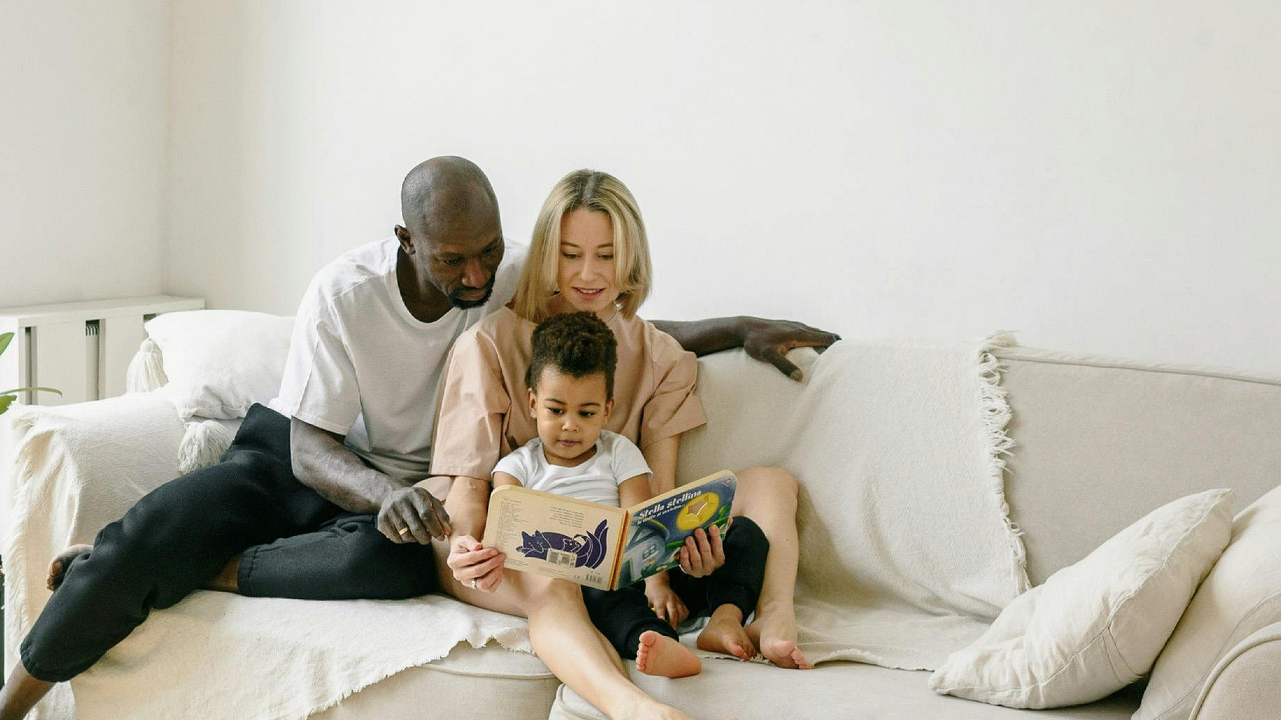 family-sitting-on-gray-couch