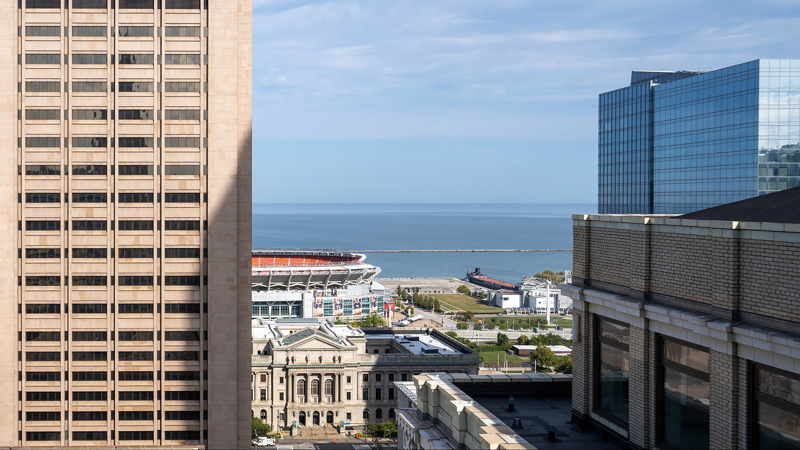 Scenic urban view with office buildings and a stunning water backdrop.