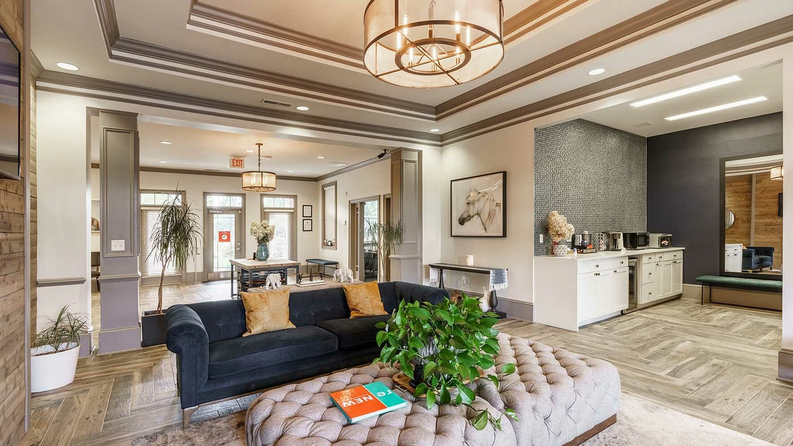 Elegant living room with chic decor, featuring a plush sofa, modern lighting fixtures, and a cozy sitting area.
