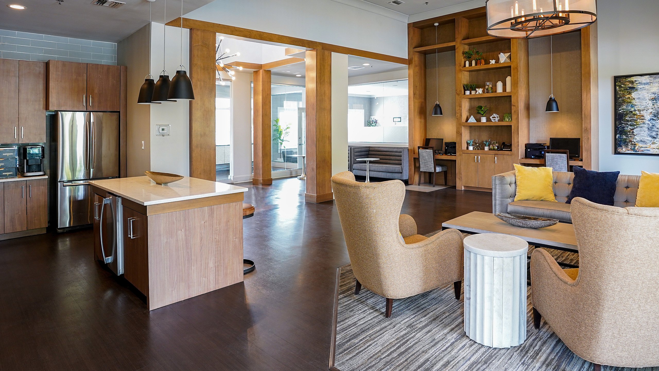 Elegant open-concept living area featuring a modern kitchen, cozy lounge with plush seating, and stylish decor accents.