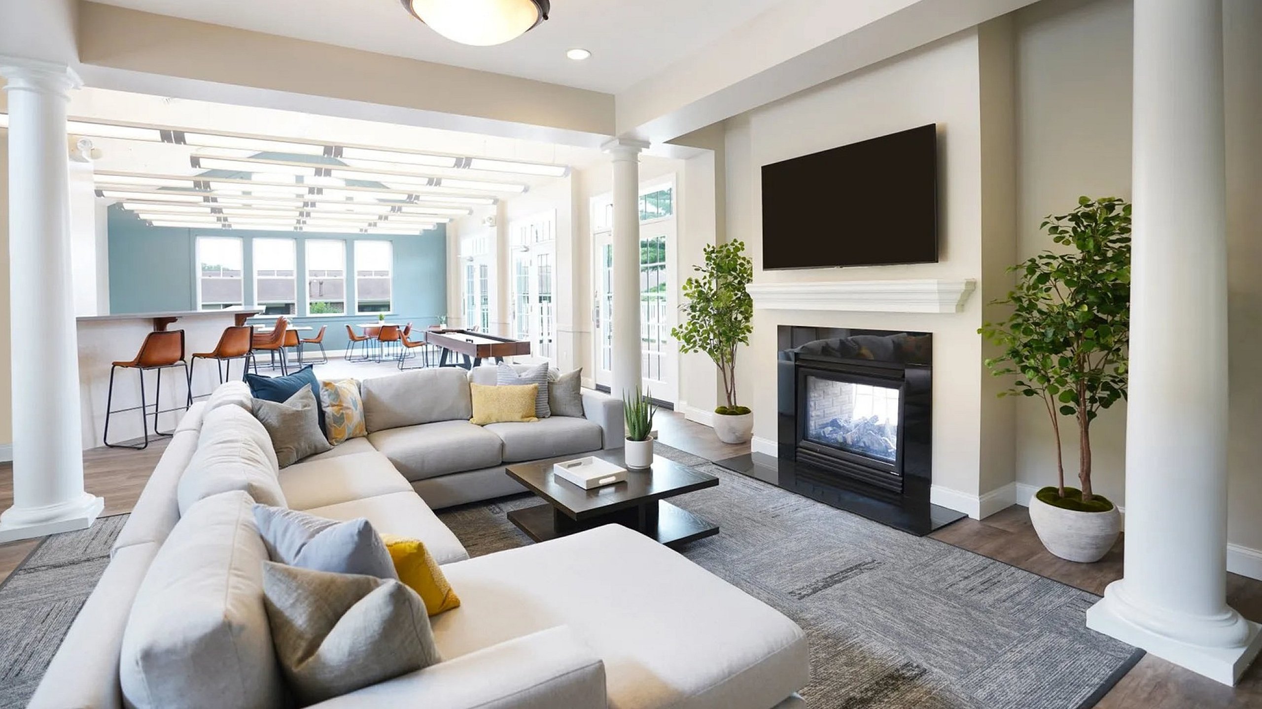 Spacious and elegant living room with plush seating, modern decor, and a cozy fireplace, perfect for relaxation and entertainment.