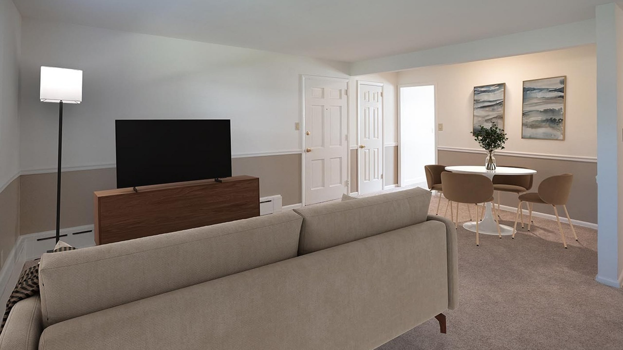 Elegant living room with cozy sofa, sleek TV stand, modern dining area, and tasteful artwork.
