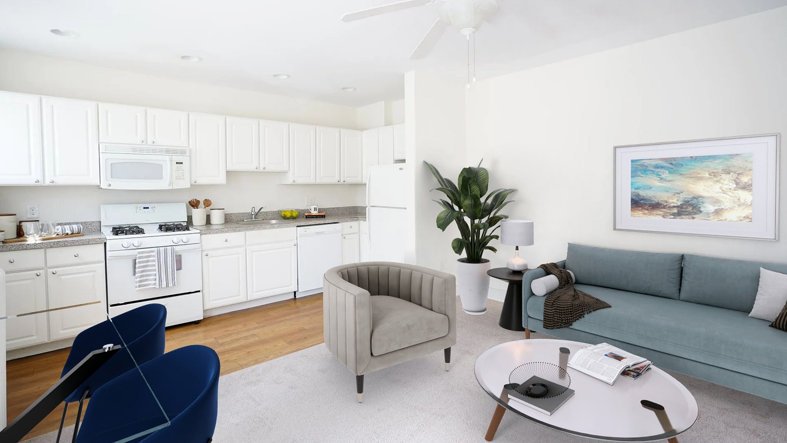 Bright and modern living space with a cozy seating area, elegant coffee table, and spacious kitchen featuring sleek white cabinetry and appliances.