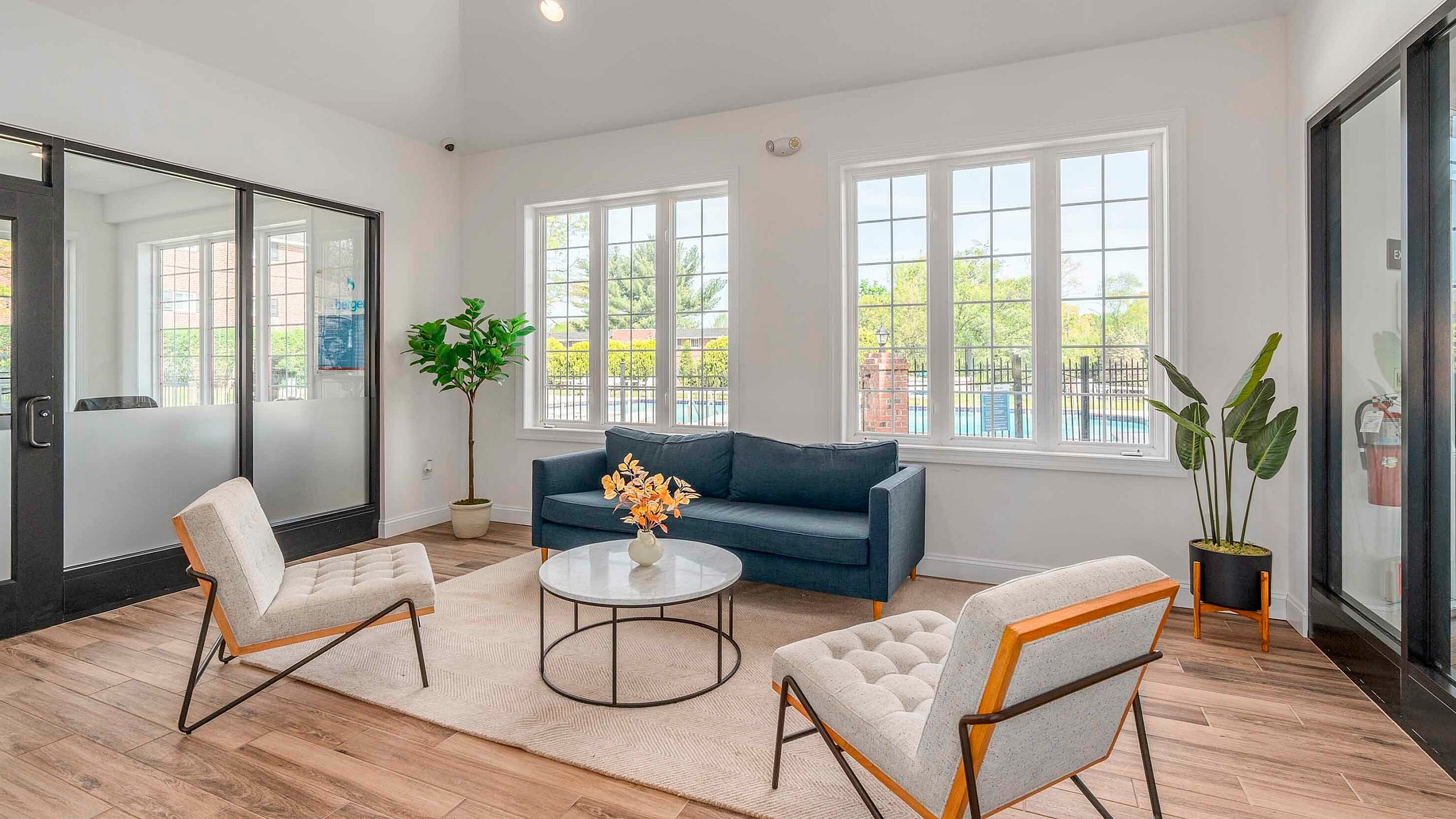 Bright, modern living room with large windows, contemporary furniture, and elegant decor, perfect for relaxing and entertaining.