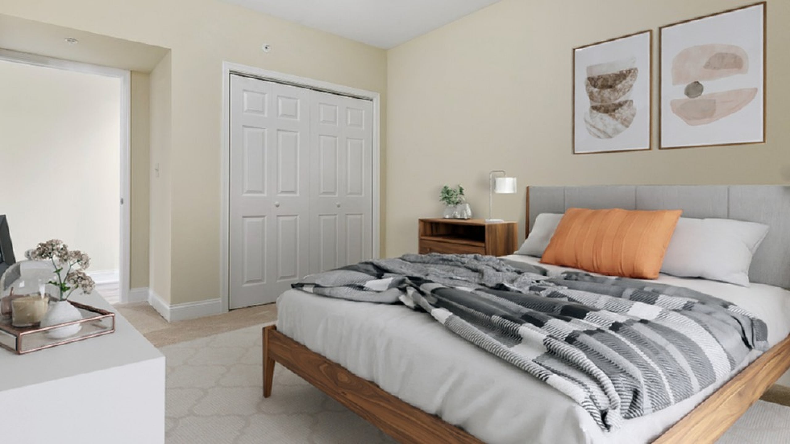 Inviting bedroom with modern decor, featuring a cozy bed, elegant artwork, and abundant natural light.