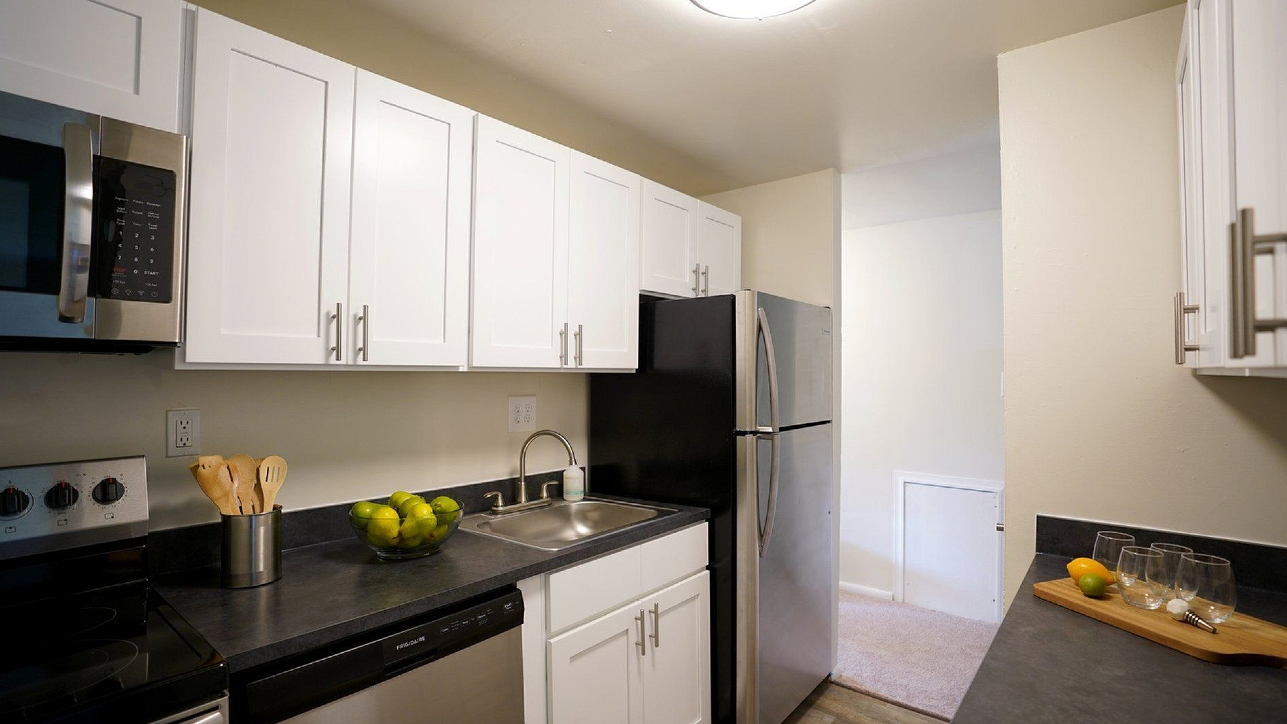 Modern kitchen with sleek stainless steel appliances, white cabinetry, and elegant countertops, perfect for culinary creativity.