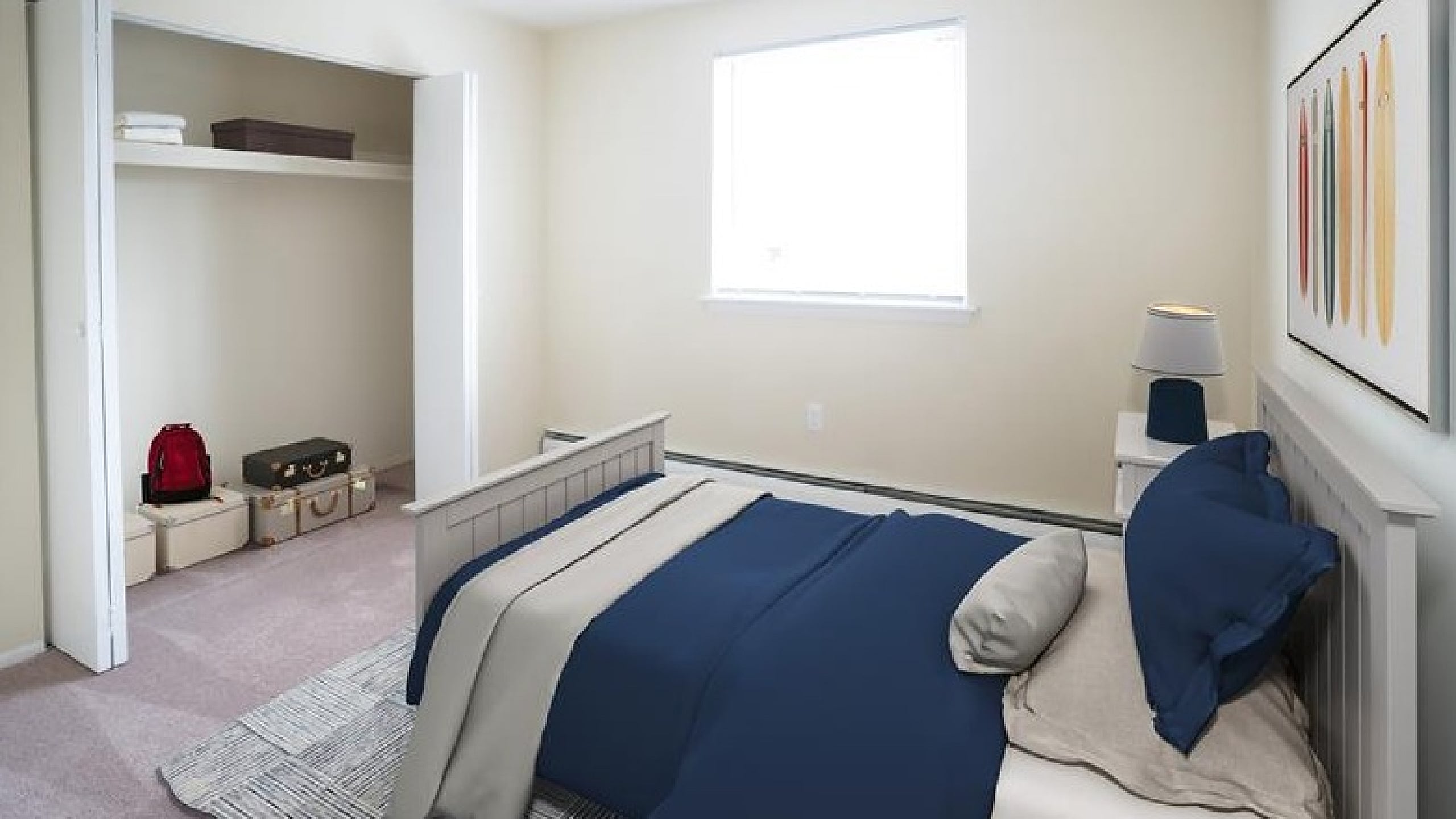 Cozy bedroom with chic navy bedding, bright window, spacious closet, and modern decor.