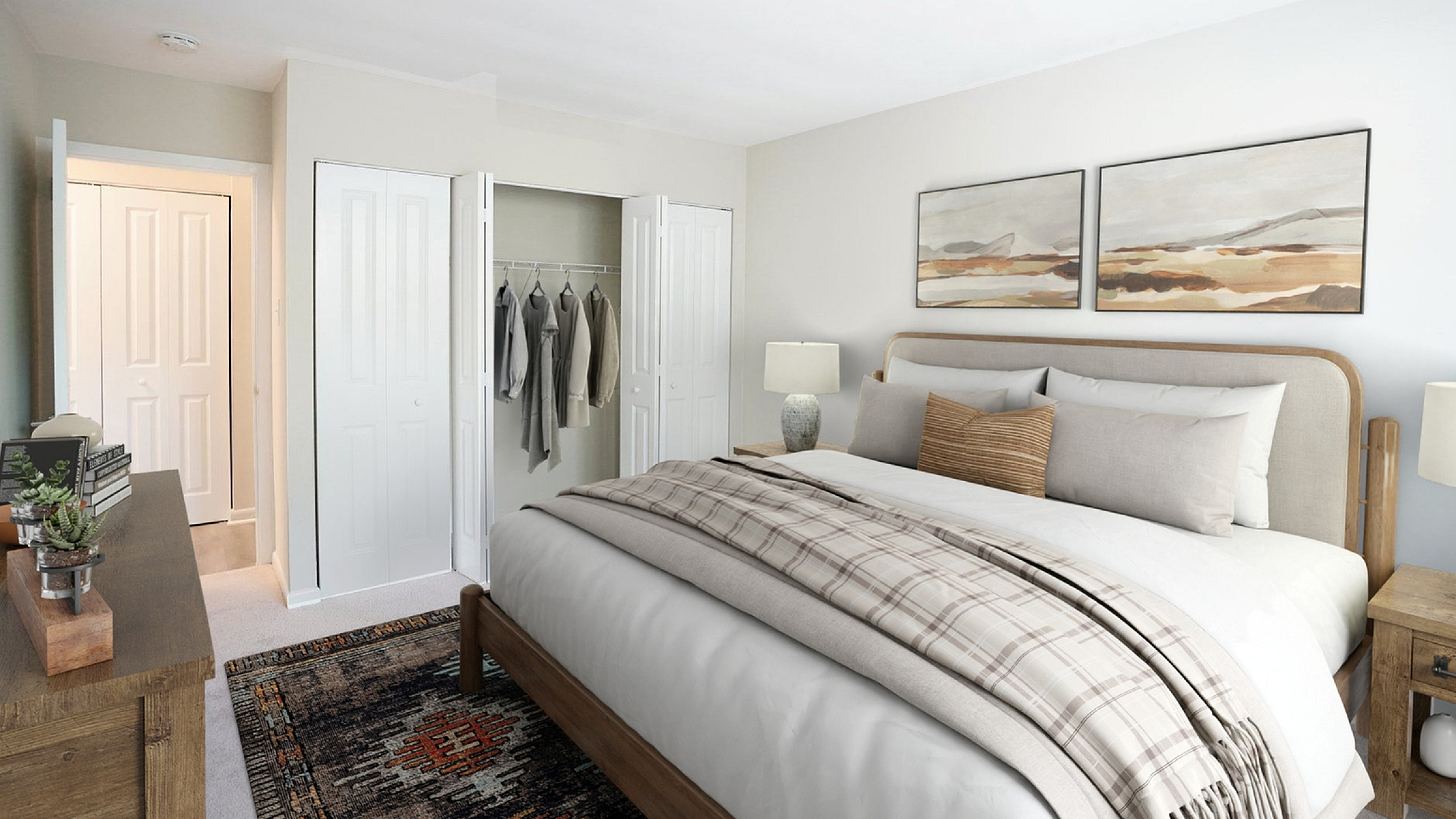 Cozy bedroom featuring a plush bed with soft linens, elegant decor, and spacious closet with neatly arranged clothes.