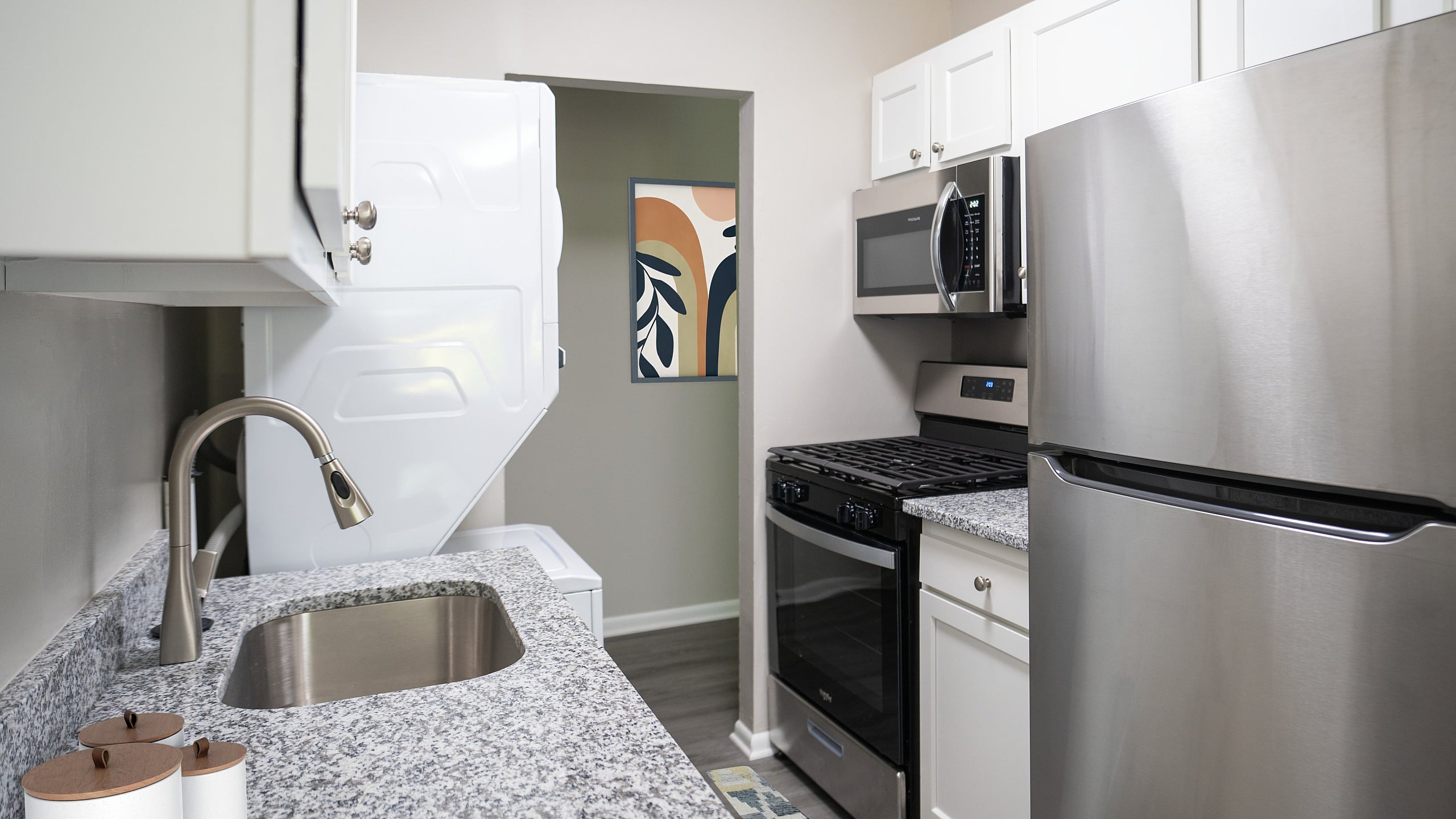 Modern kitchen featuring sleek stainless steel appliances, granite countertops, and elegant cabinetry.
