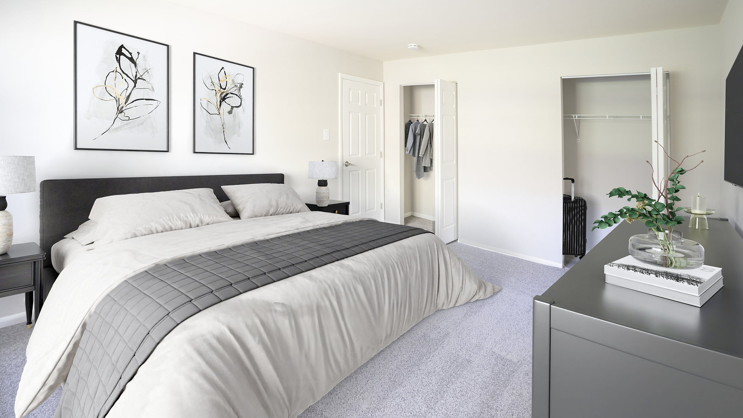 Elegant bedroom with modern decor, featuring a plush bed, minimalist artwork, and spacious closet, ideal for a cozy retreat.