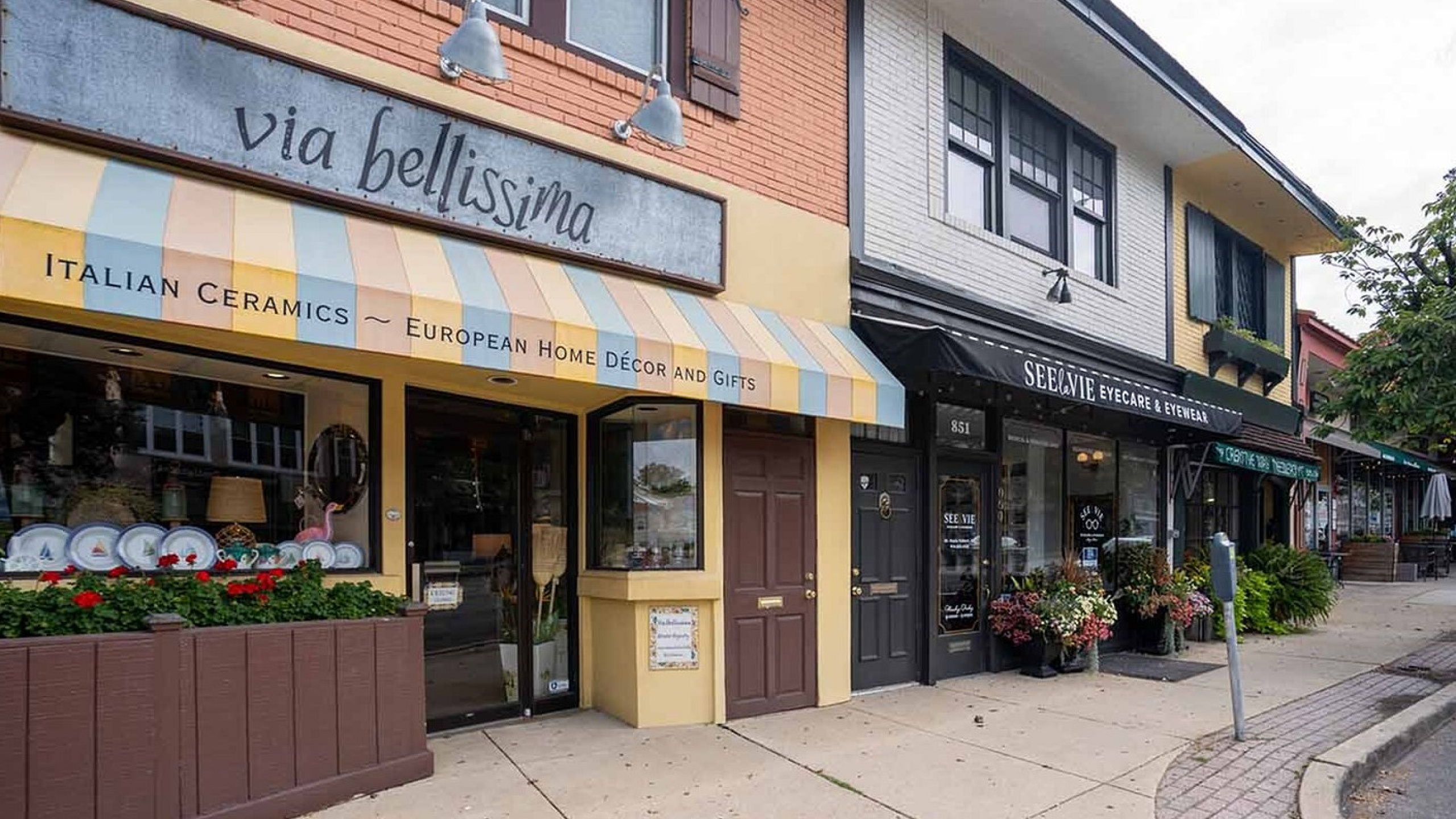 Charming boutique storefronts featuring Italian ceramics and stylish eyewear, set on a quaint, vibrant street.