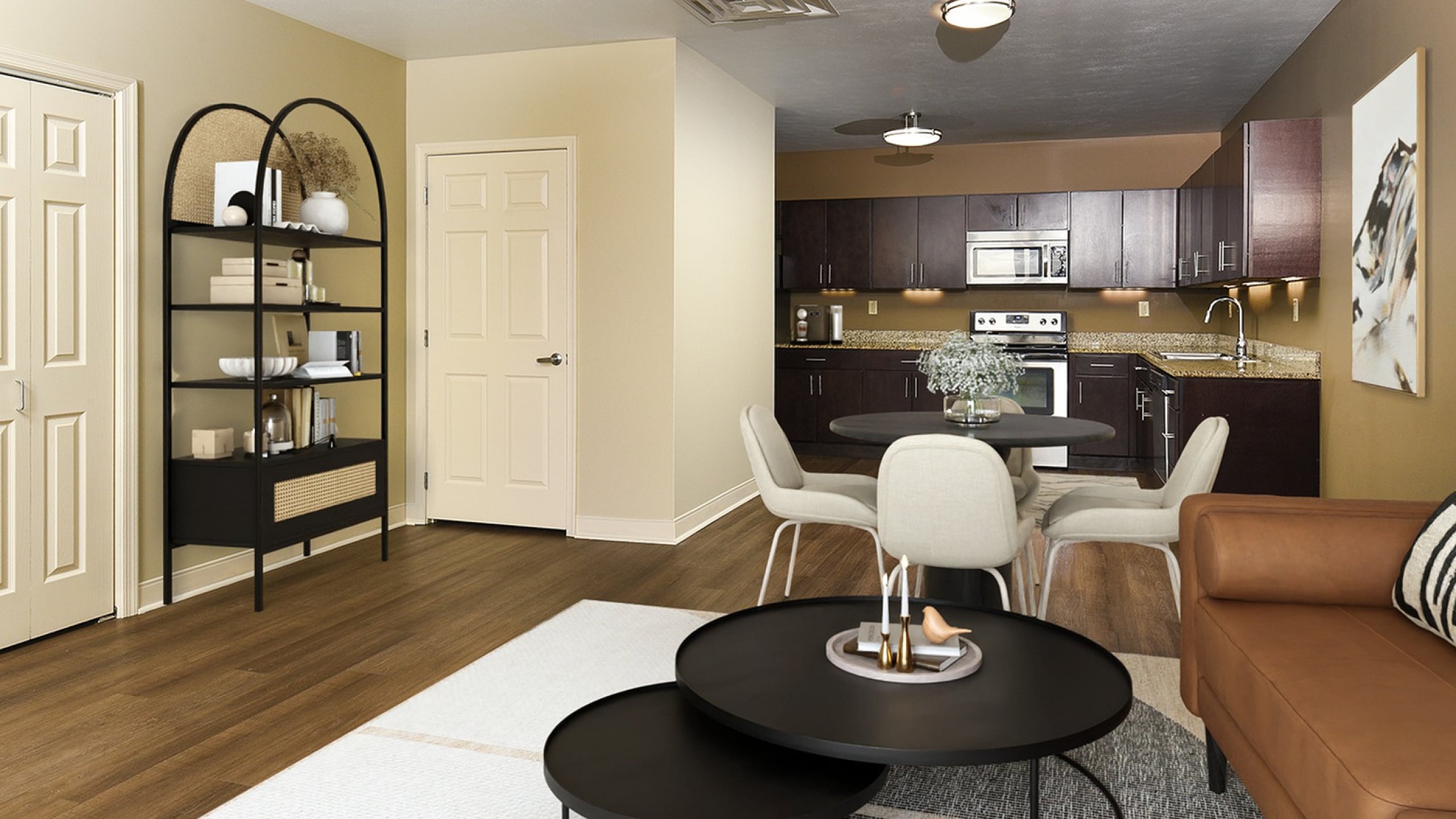 Inviting open-concept living space featuring a sleek kitchen with dark wood cabinets, cozy dining area, and stylish lounge adorned with modern decor.
