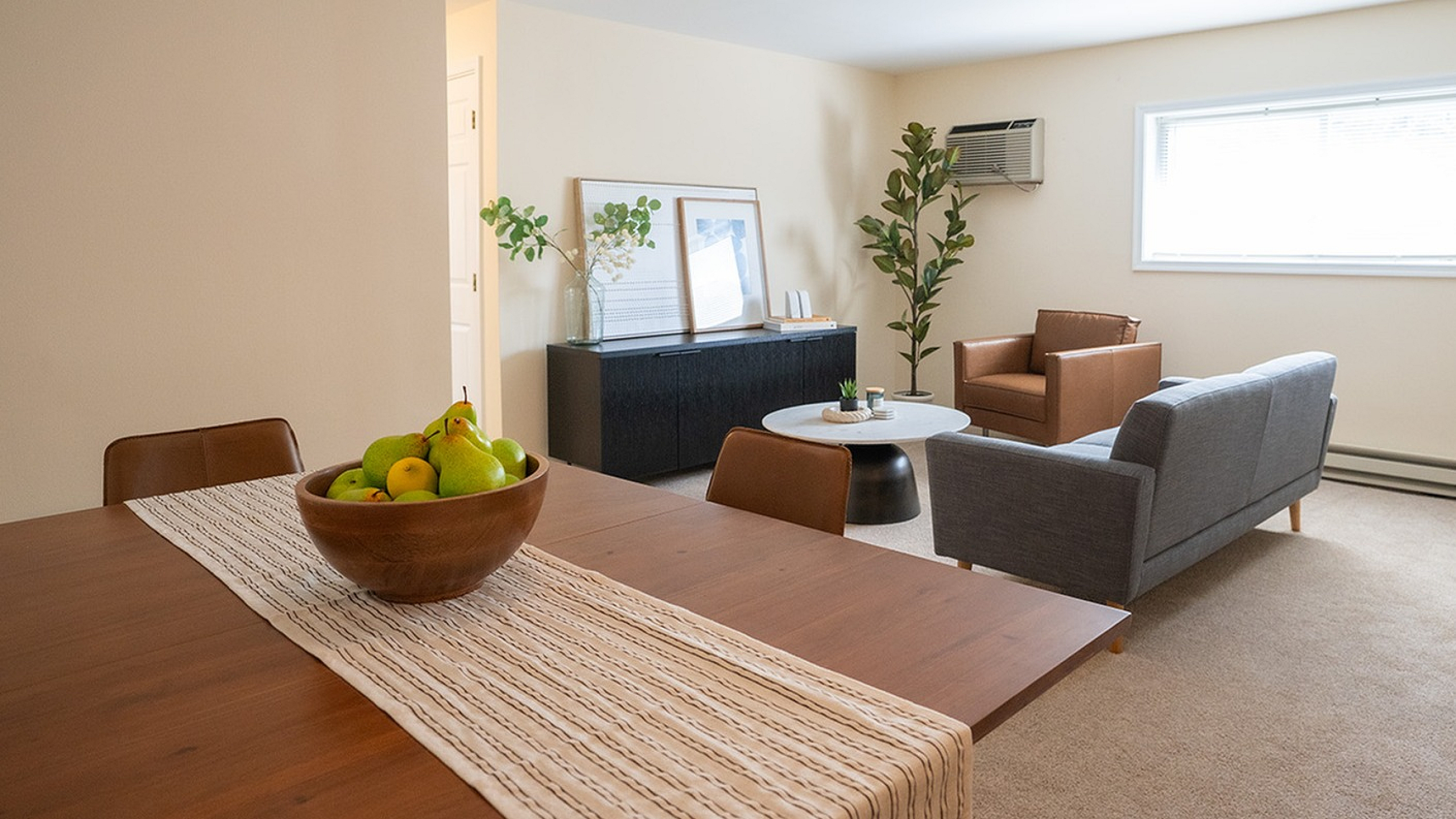 Inviting open-concept living room featuring cozy seating, stylish decor, and warm lighting, perfect for relaxation and entertaining.