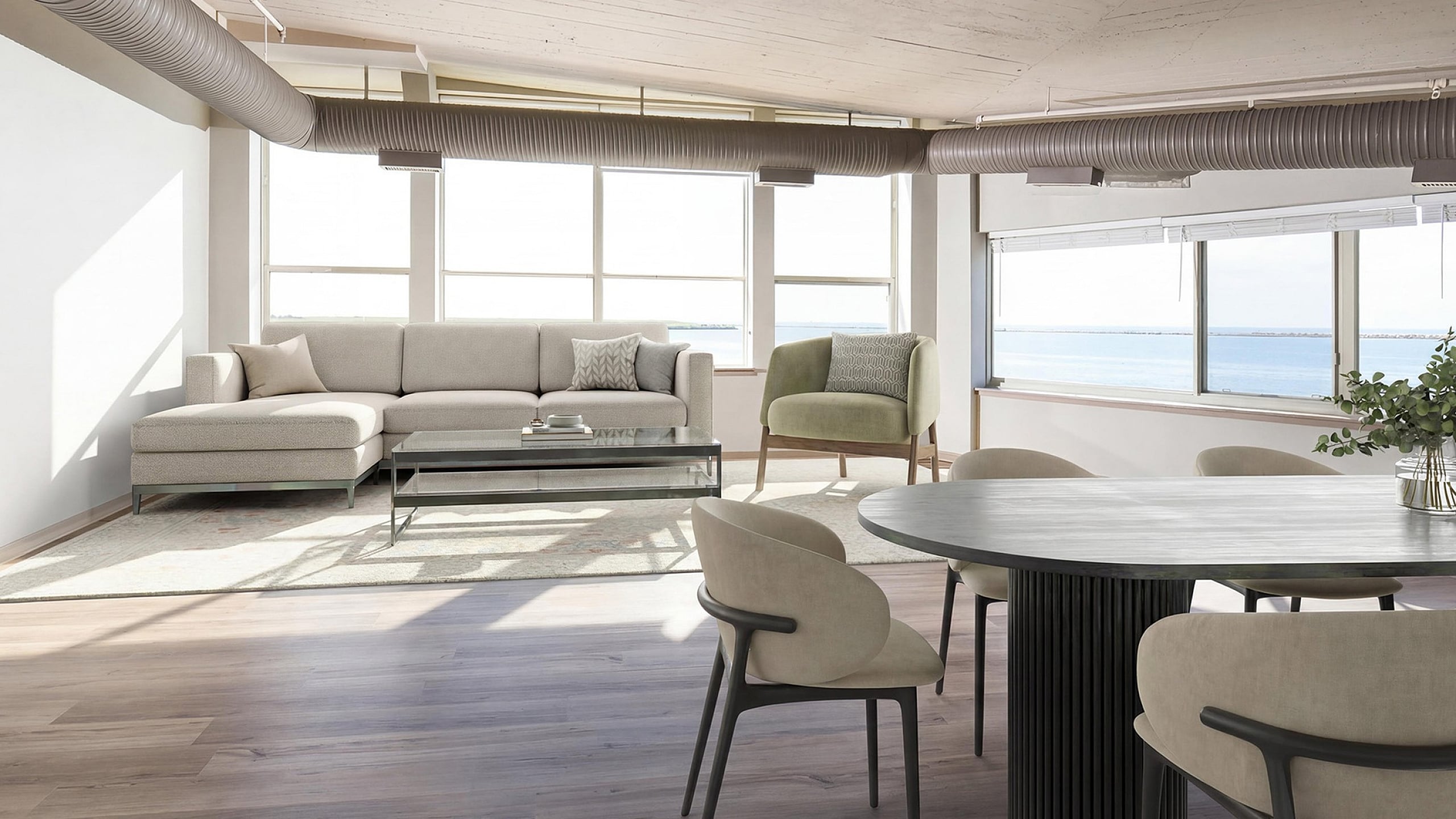 Modern living area with elegant furniture, large windows offering ocean views, and sleek industrial design elements.