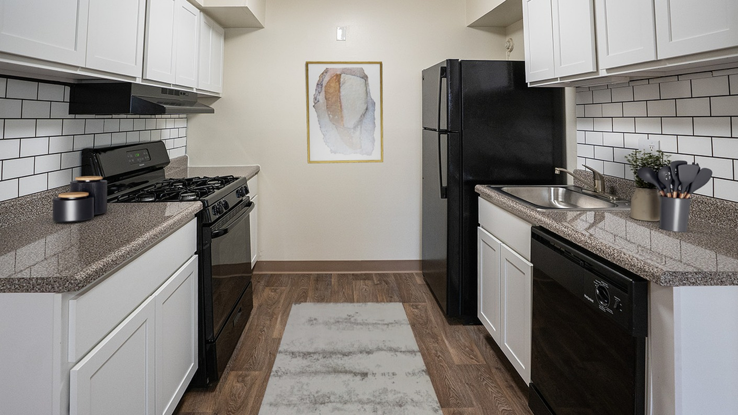 Modern kitchen with sleek cabinetry, granite countertops, and stainless steel appliances, highlighting a stylish, open design.