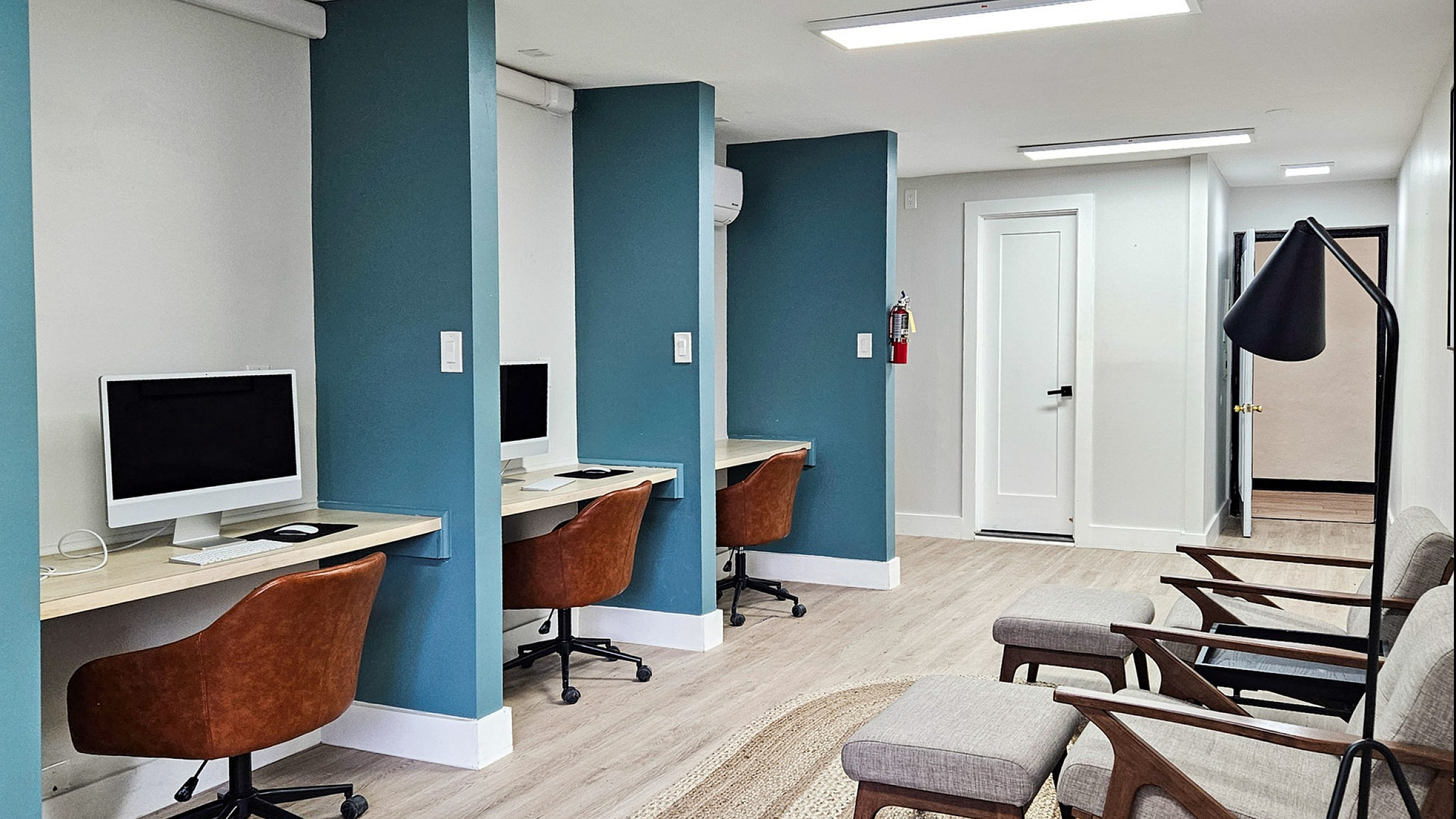 Modern workspace with sleek desks, ergonomic chairs, and ambient lighting, ideal for productivity and comfort.