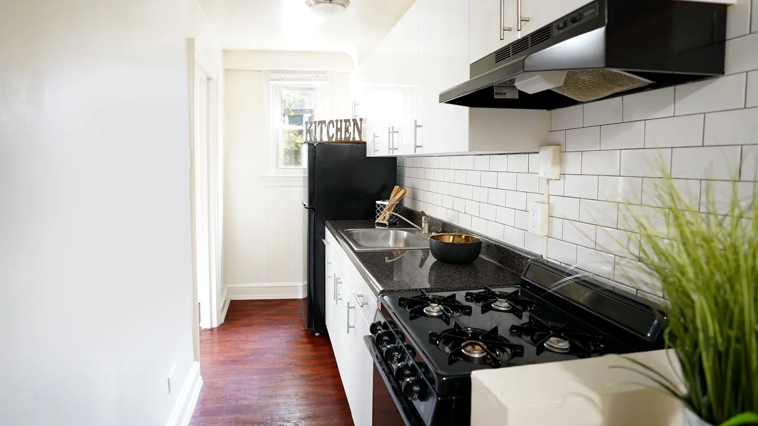 Charming kitchen with sleek countertops, modern appliances, and stylish white cabinetry, perfect for culinary enthusiasts.