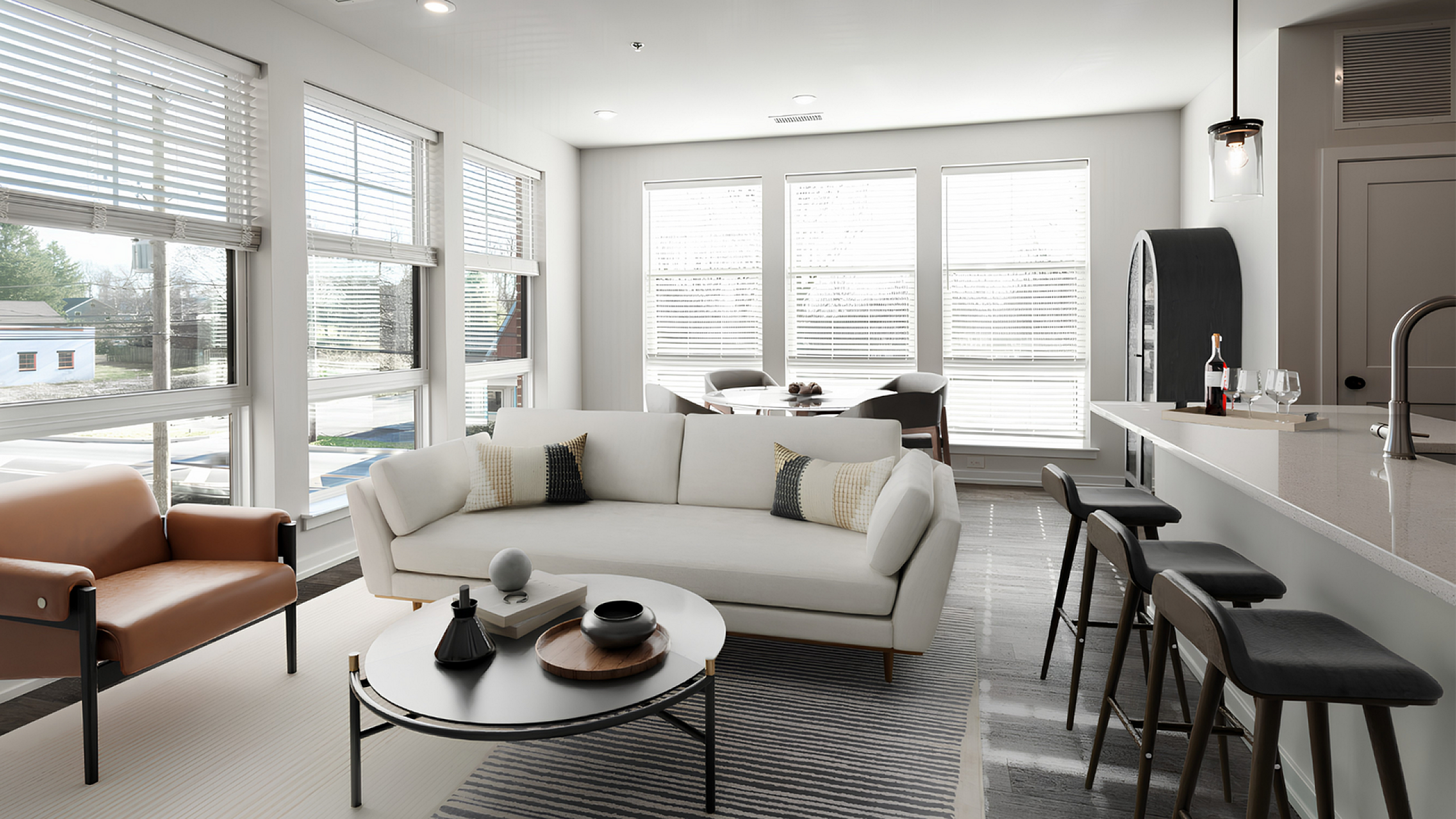 Bright and modern open-concept living area with stylish furnishings, large windows, and a sleek kitchen island in a luxury apartment.