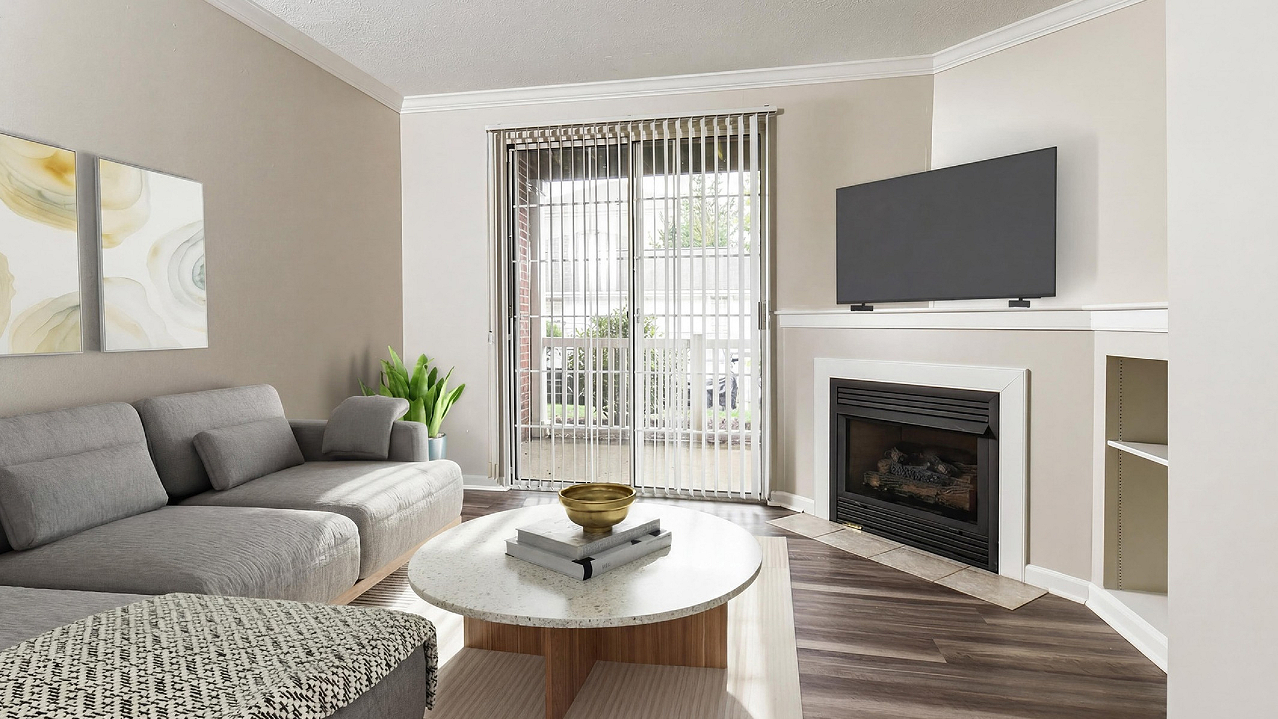 Chic living room with a modern gray sectional, sleek coffee table, and cozy fireplace, complemented by natural light streaming through vertical blinds.