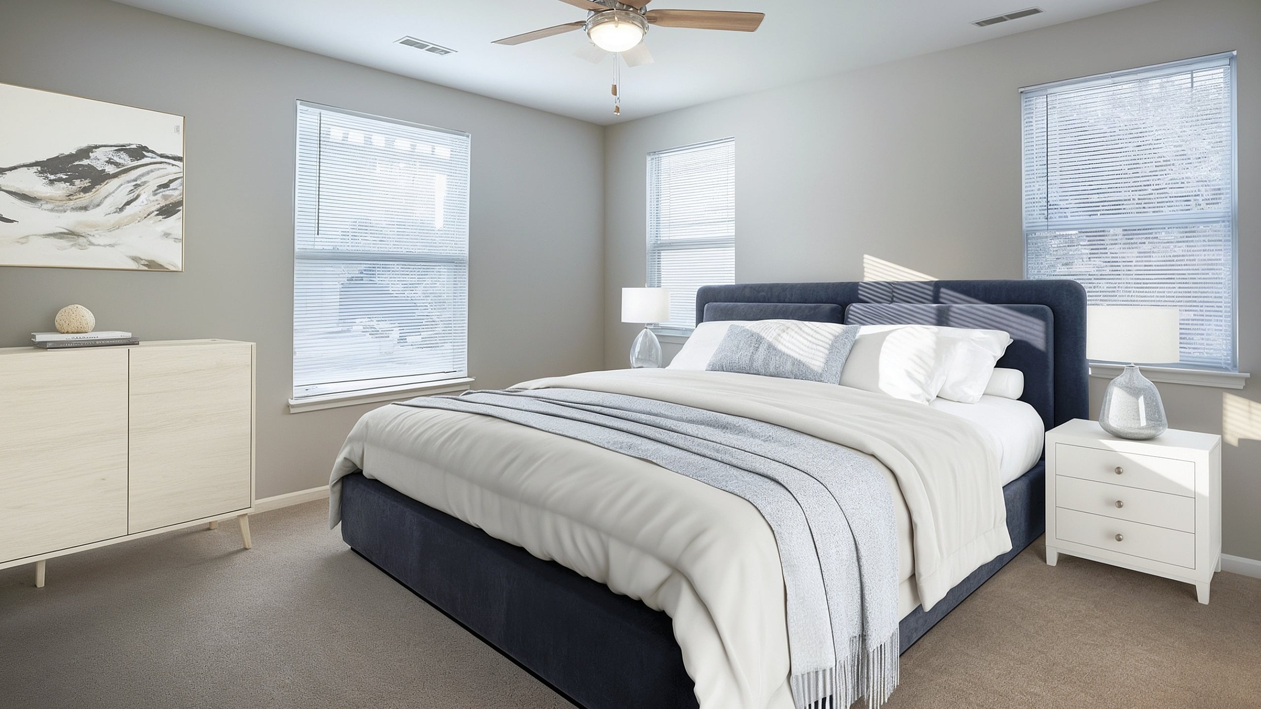 Cozy bedroom featuring a luxurious bed with elegant decor, modern ceiling fan, and abundant natural light through large windows.