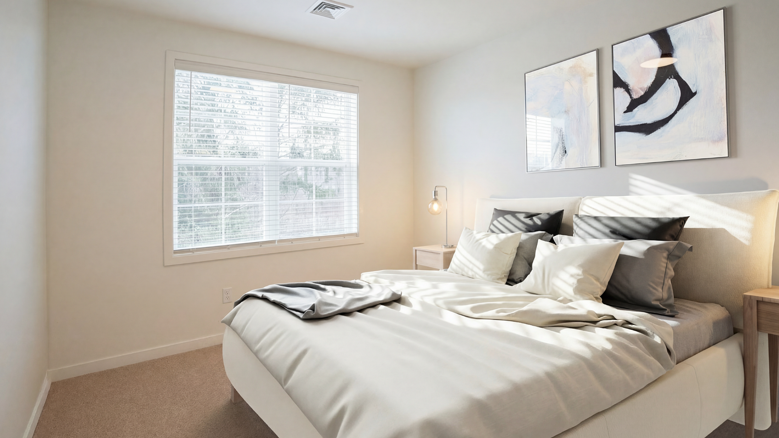 Bright and cozy bedroom with modern decor, featuring a sunlit window, plush bedding, and stylish artwork.
