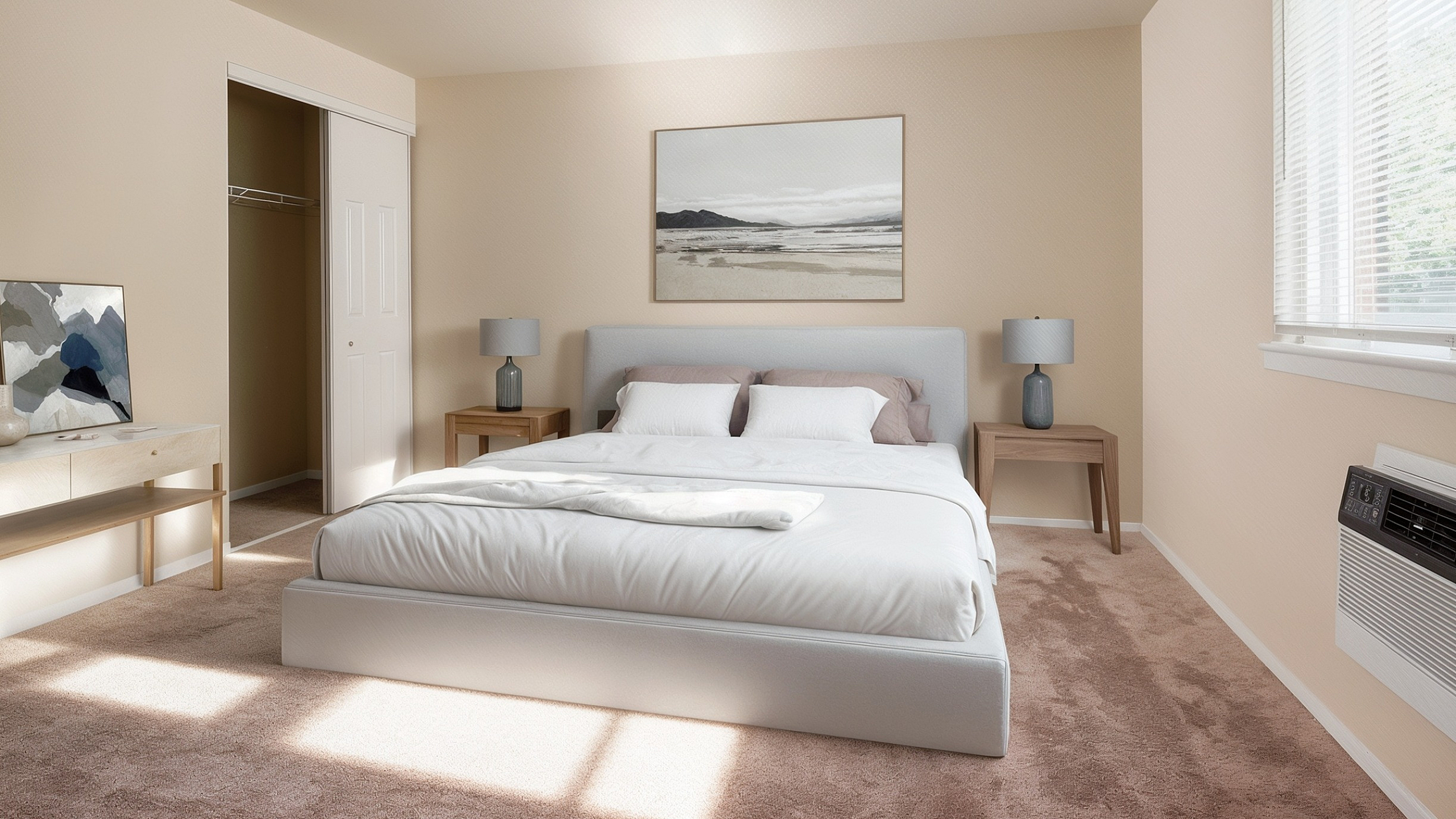 Inviting bedroom with soft beige tones, plush carpet, and modern furnishings, offering a serene retreat.