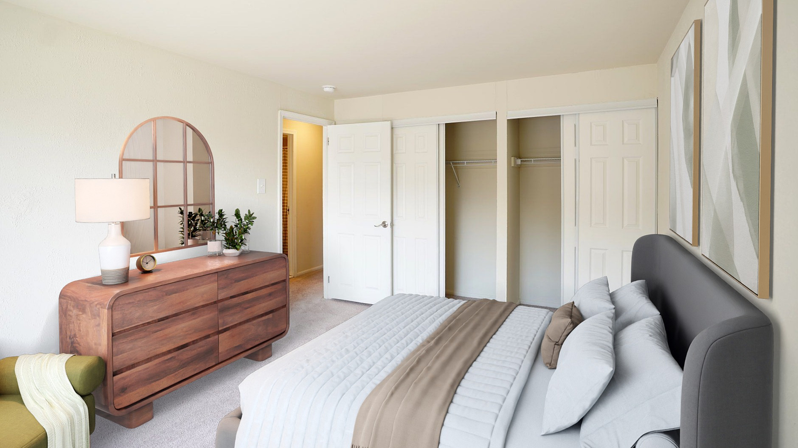 Bright and inviting bedroom featuring elegant decor, cozy bed, stylish dresser, and spacious closet.